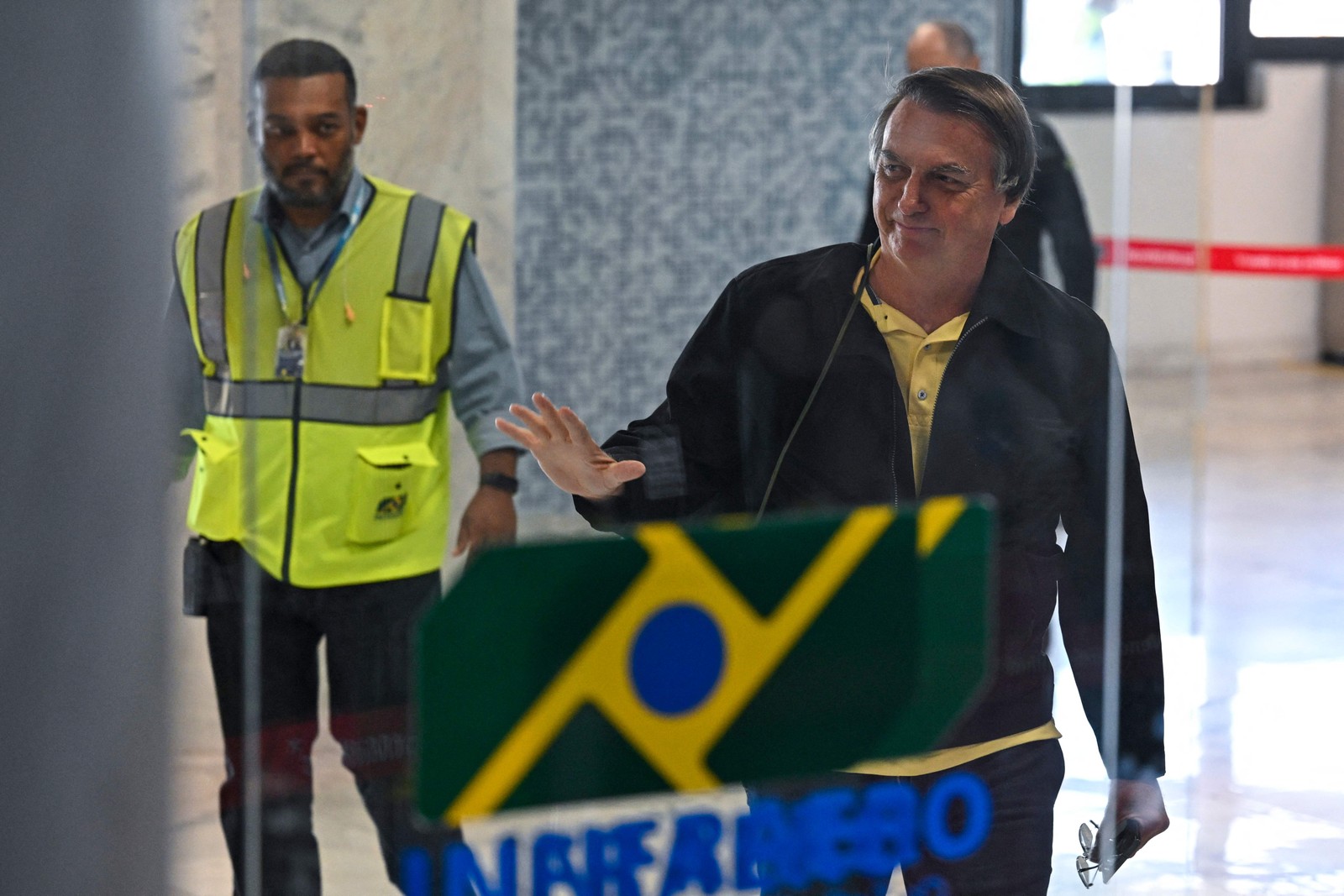 O ex-presidente Jair Bolsonaro acena ao chegar ao Aeroporto Santos Dumont, no Rio de Janeiro — Foto: MAURO PIMENTEL/AFP