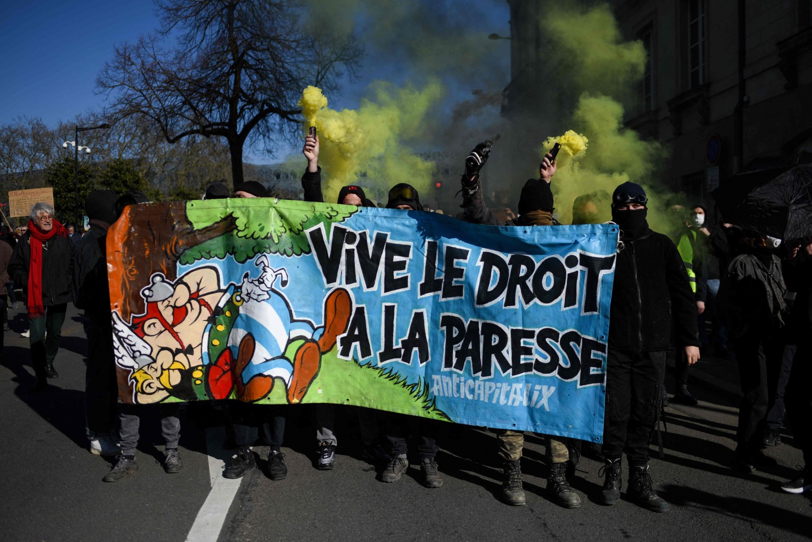 Faixa com os dizeres "Vida longa ao direito de ser preguiçoso!" é levada por manifestantes durante o maior protesto de 2023 contra a reforma da Previdência — Foto: Sebastien Salom-Gomis/AFP