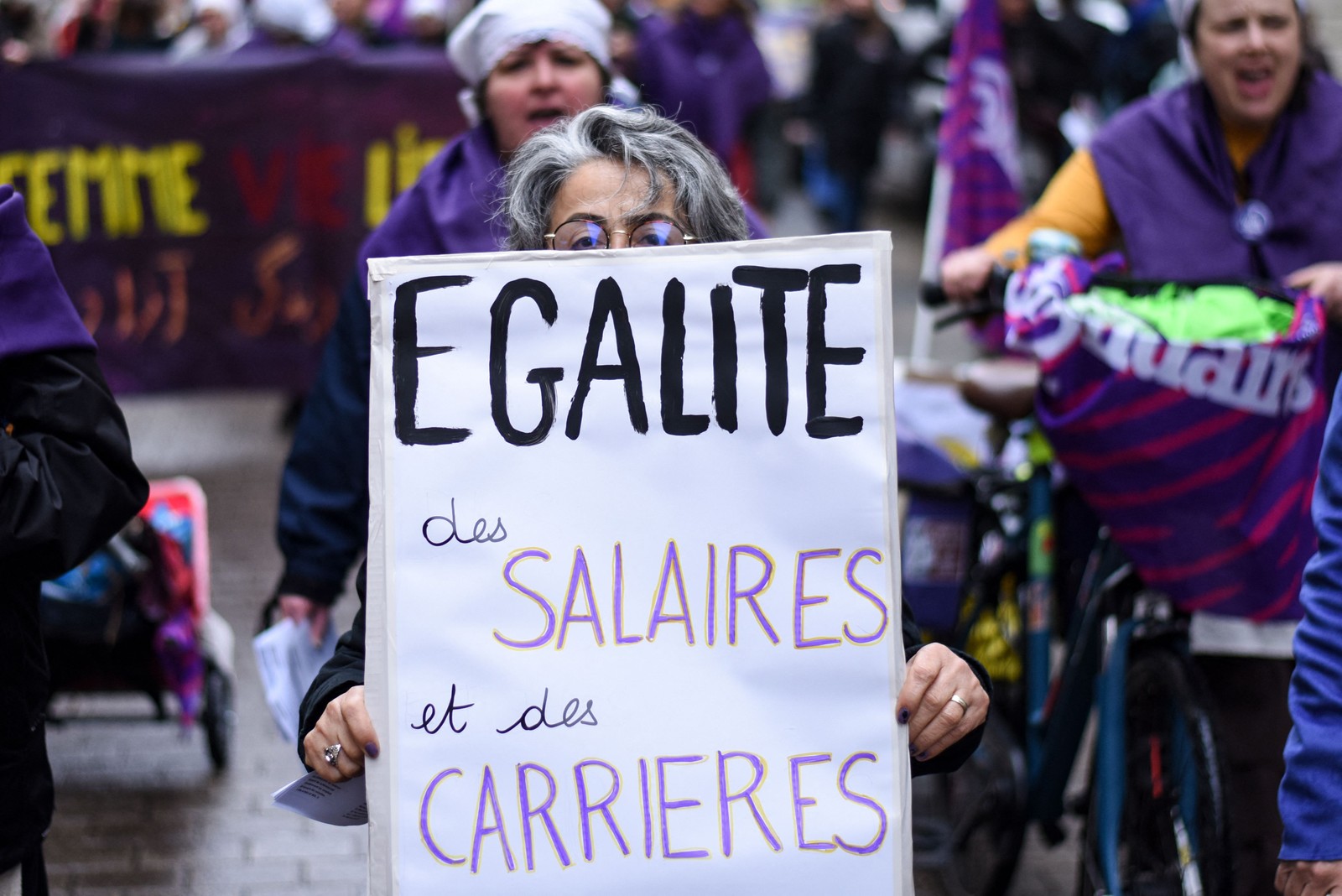 Cartaz que diz "Igualdade em salários e carreiras" aparece em manifestação para marcar o Dia Internacional da Mulher, em 2023, em Nantes, no oeste da França. Sebastien Salom-Gomis / AFP