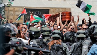 Forças de segurança de Israel impedem que pessoas carreguem o caixão com o corpo da jornalista da al-Jazeera Shireen Abu Akle durante uma procisão funerária para uma igreja, em JerusalémAFP