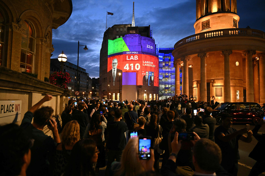 Painel luminoso mostra pesquisa de boca de urna apontando para vitória do Partido Trabalhista no Reino Unido
