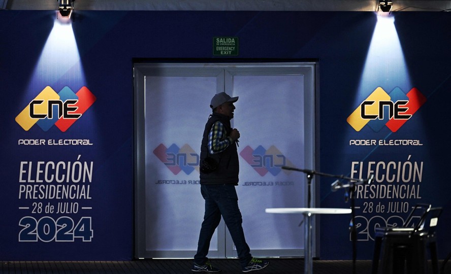 Homem caminha dentro do centro de mídia do Conselho Nacional Eleitoral em Caracas