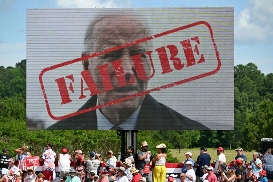 Cartaz com foto de Biden escrito 'fracasso' em comício de Donald Trump após debate
