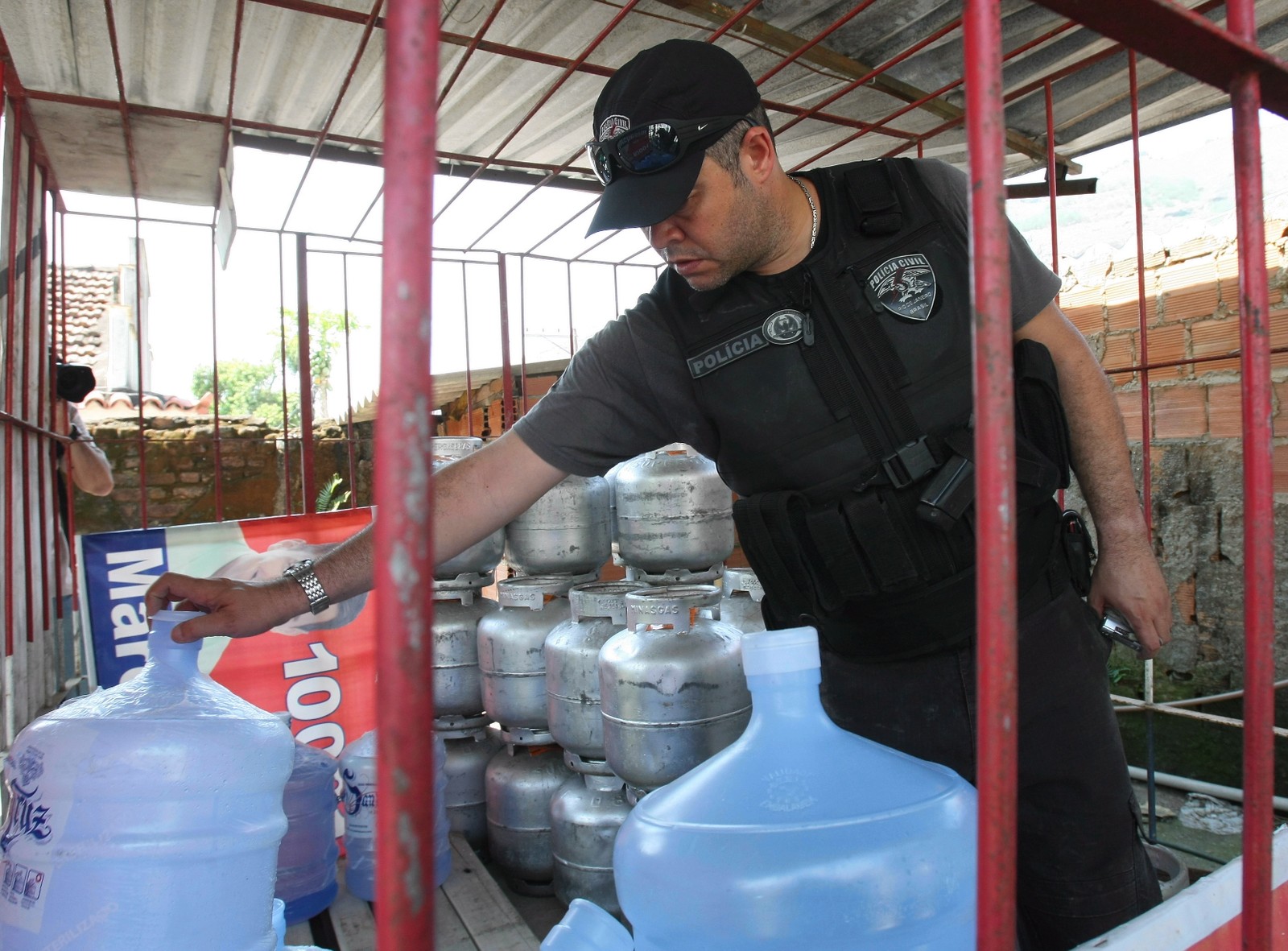 2010. A Polícia Civil faz, desde o início da manhã desta quinta-feira, uma operação para reprimir a milícia na zona norte. No Morro do Dezoito, em Água Santa, três pessoas foram presas. Na comunidade, os policiais encontraram uma casa que servia de quartel general para a quadrilha. No local foi encontrada uma grande quantidade de armas e munição, além de um binóculo que servia para os bandidos vigiarem a comunidade — Foto: Bruno Gonzalez / EXTRA / Agência O Globo