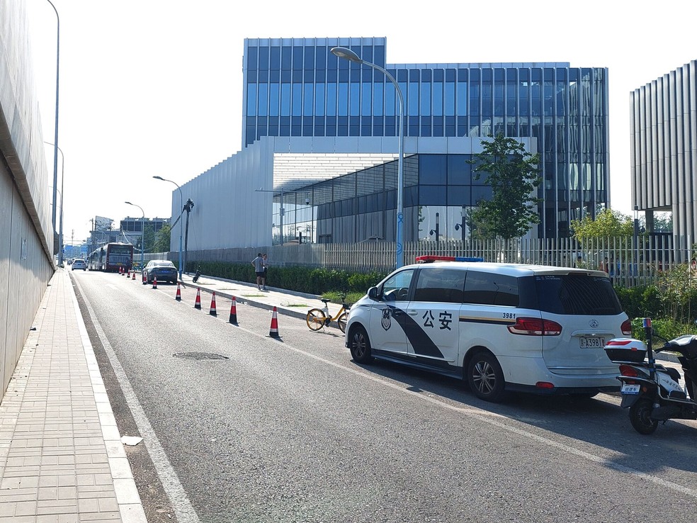 Veículos da polícia estacionados perto dos escritórios de Zhongrong, para evitar que os protestos aumentem — Foto: Bloomberg