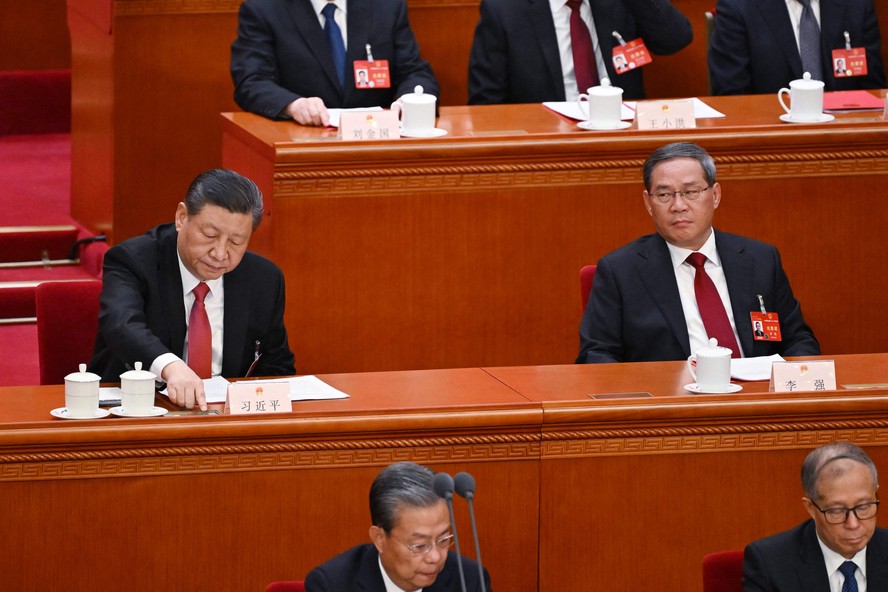 Presidente da China, Xi Jinping (E) vota durante o Congresso Nacional do Povo, observado pelo premier Li Qiang