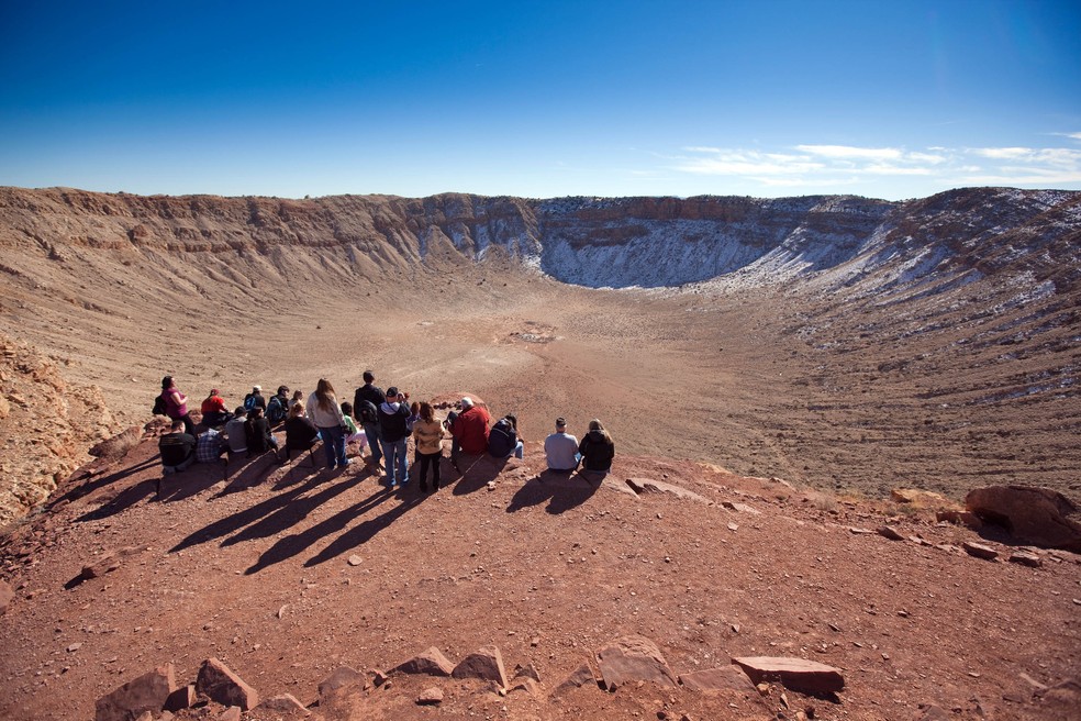 Visitantes olham para a borda da Cratera do Meteoro, no Arizona, em 17 de janeiro de 2009. — Foto: John Burcham/The New York Times