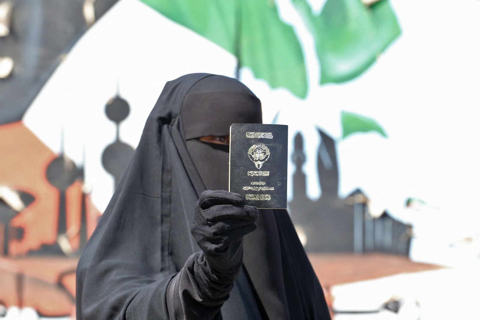 Mulher kuwaitiana exibe seu passaporte enquanto vota durante as eleições parlamentares na cidade do Kuwait. — Foto: Yasser Al-Zayyat / AFP