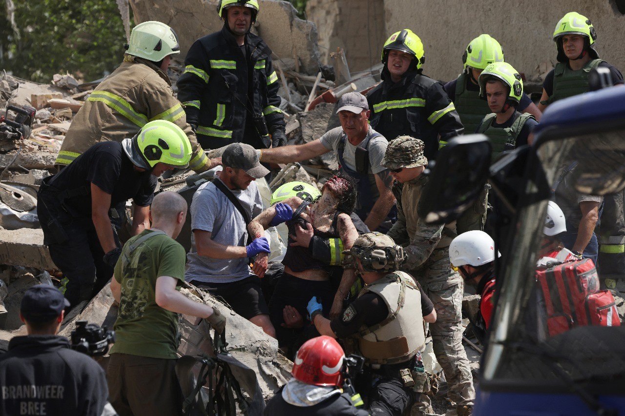 Equipes de emergência e resgate retiram uma mulher ferida dos escombros de um prédio residencial; quatro pessoas morreram — Foto: Anatolii Stepanov/AFP