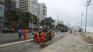 Equipes da Comlurb fazem a retirada de areia das pistas e do calçadão na Praia do Leblon — Foto: Fabiano Rocha/Agência O Globo