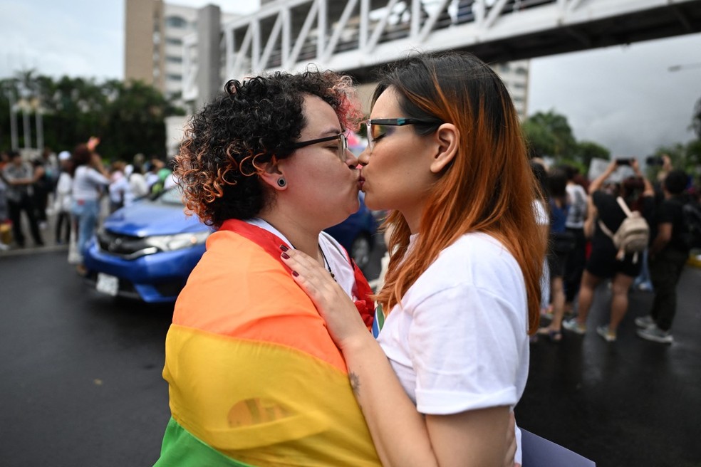 Fiorella Turchkeim (E) e Andrea Ordoñez se beijam na Parada do Orgulho em San Salvador em 29 de junho de 2024 — Foto: MARVIN RECINOS / AFP