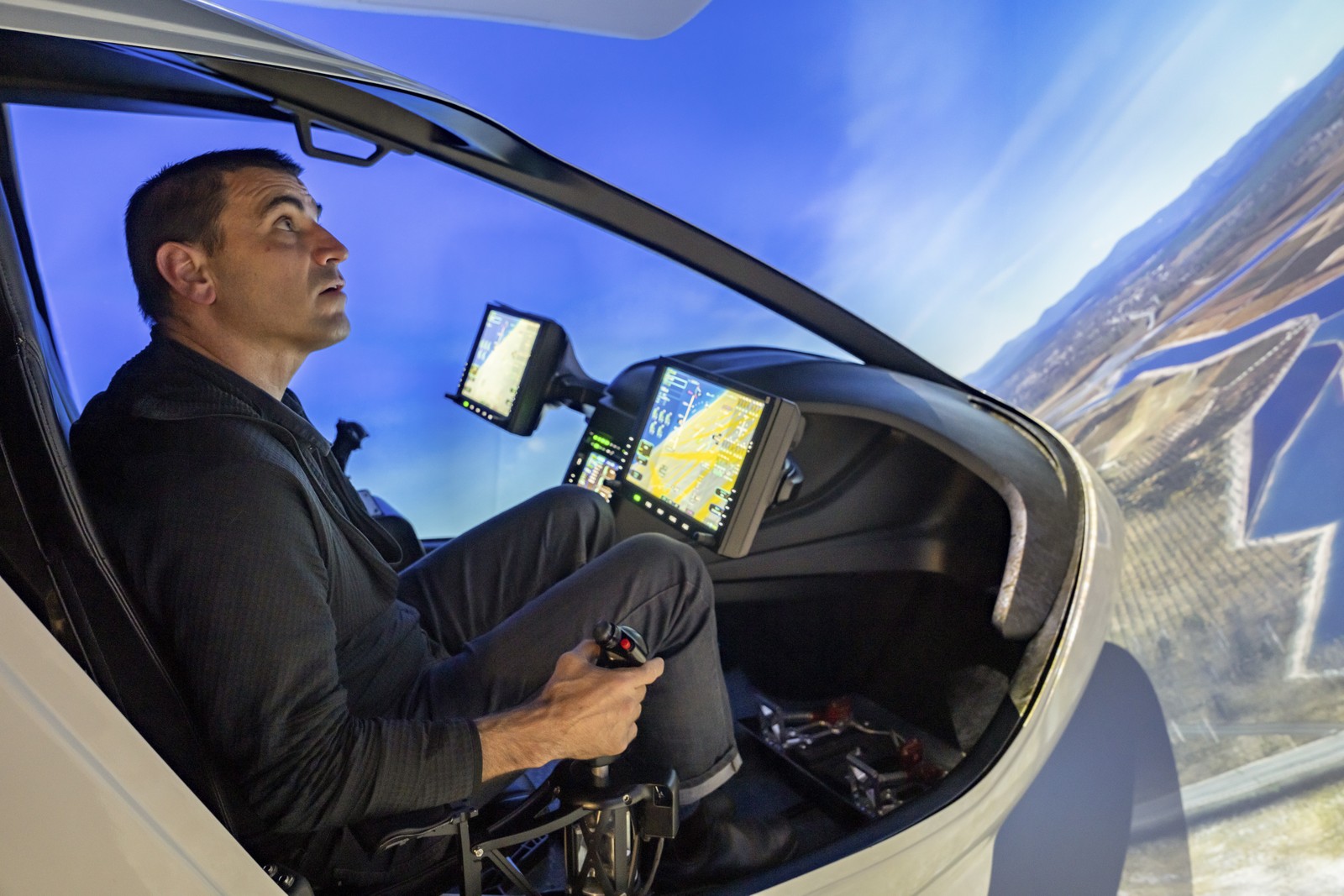 O piloto Chris Caputo dentro de um simulador de treinamento de voo em Burlington. Espera-se que as aeronaves elétricas concorram principalmente com helicópteros, carros e caminhões — Foto: Tony Cenicola/The New York Times