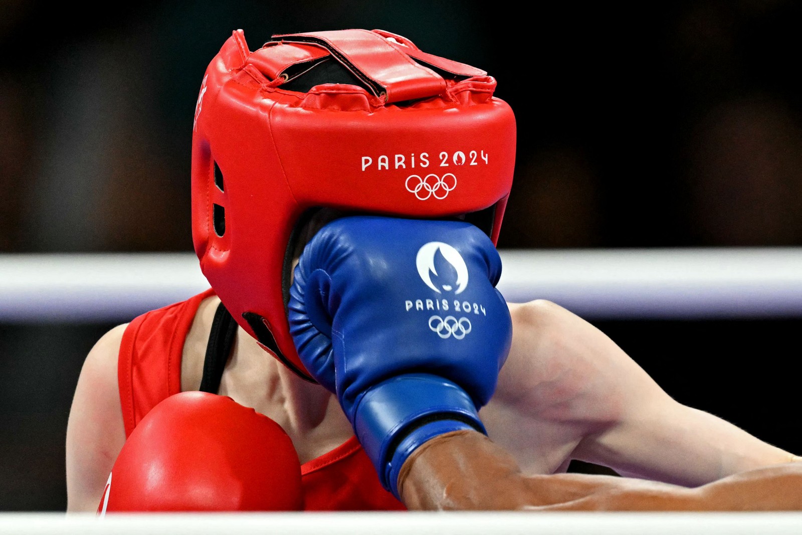 Yesugen Oyuntsetseg, da Mongólia, leva um soco da colombiana Ingrit Lorena Valencia Victoria na luta preliminar feminina de boxe — Foto: MOHD RASFAN / AFP