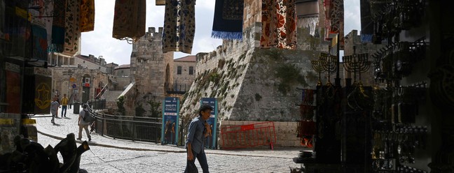 Homem caminha em ruas da antiga Jerusalém, cidade sagrada para cristianismo, islamismo e judaísmo — Foto: Yuri Cortez/AFP