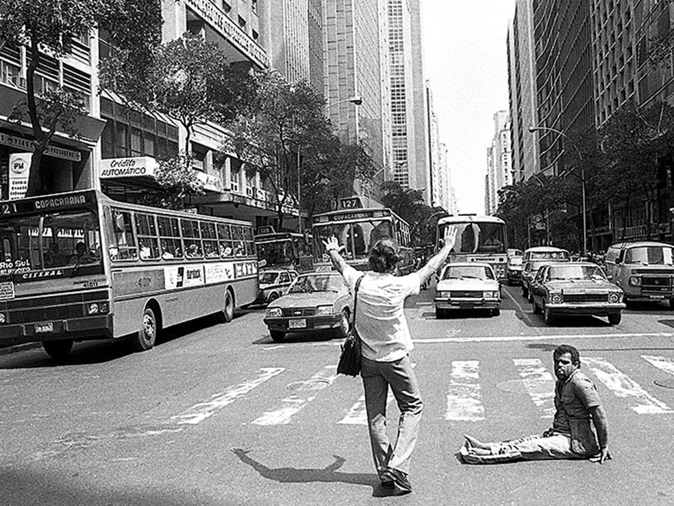 Bancário para o trânsito para ajudar homem atravessar a Rio Branco — Foto: Alberto Jacob