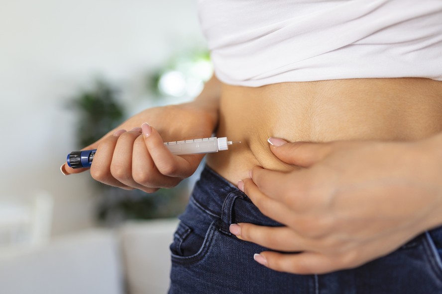 Paciente aplica medicamento na barriga. Foto: Freepik