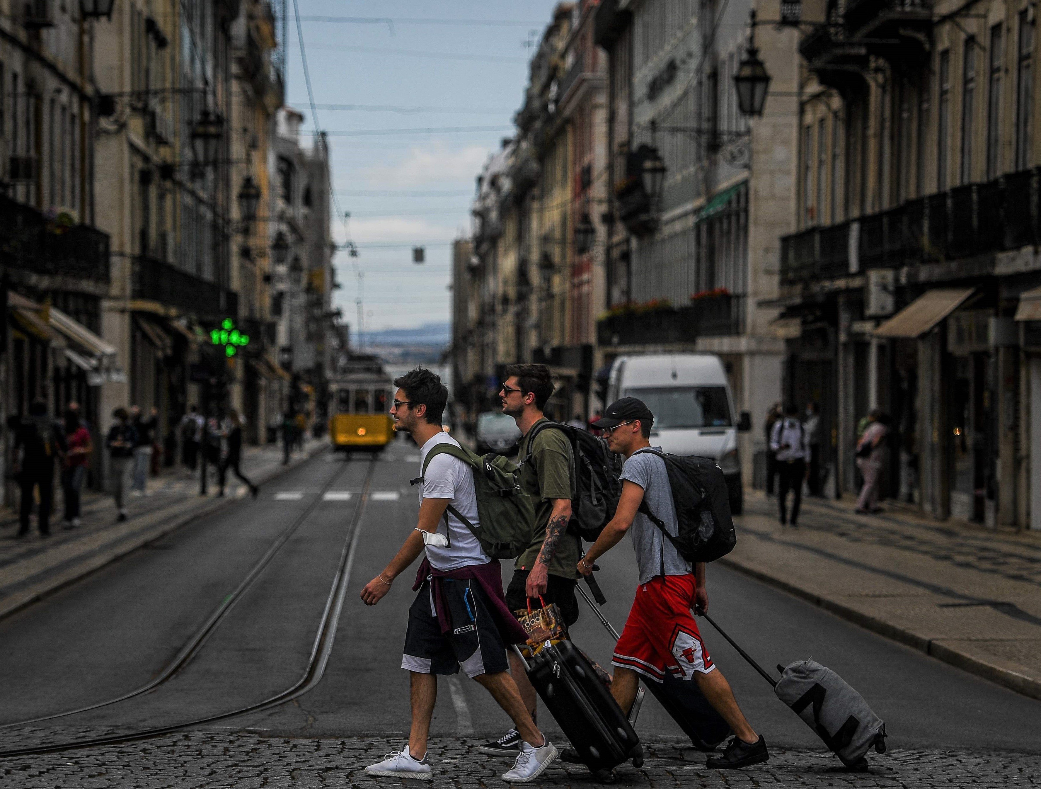 Turistas puxam suas malas pelas ruas de Lisboa