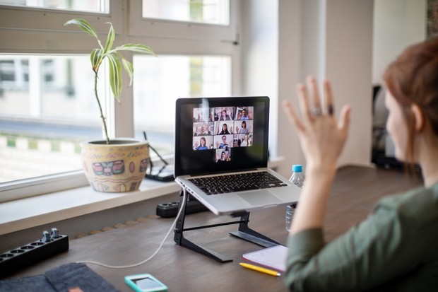 Young woman using a laptop for teleconferencing at office. Businesswoman having a video call with team members. (Foto: Getty Images)