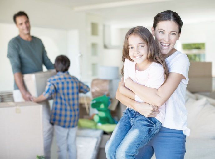 Mother and daughter hugging in new house