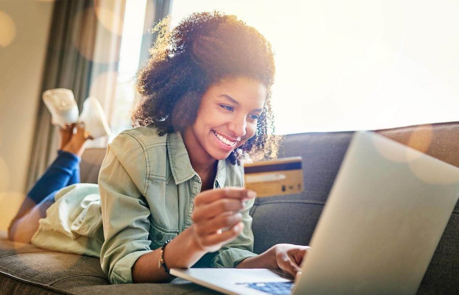 Girl Checking Credit Card on Laptop