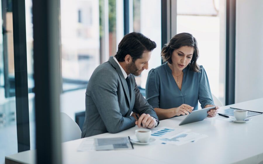 Two businesspeople reviewing loan paperwork.