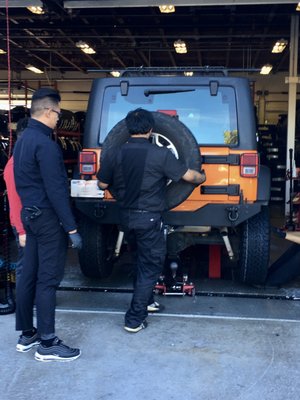 Photo of America's Tire - Millbrae, CA, US. Jordan, the manager, and his crew putting on the spare tire just moments before I drove away.