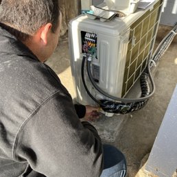 Photo of Building Efficiency - San Francisco, CA, United States. Building Efficiency Team Installing a heat pump condesner.