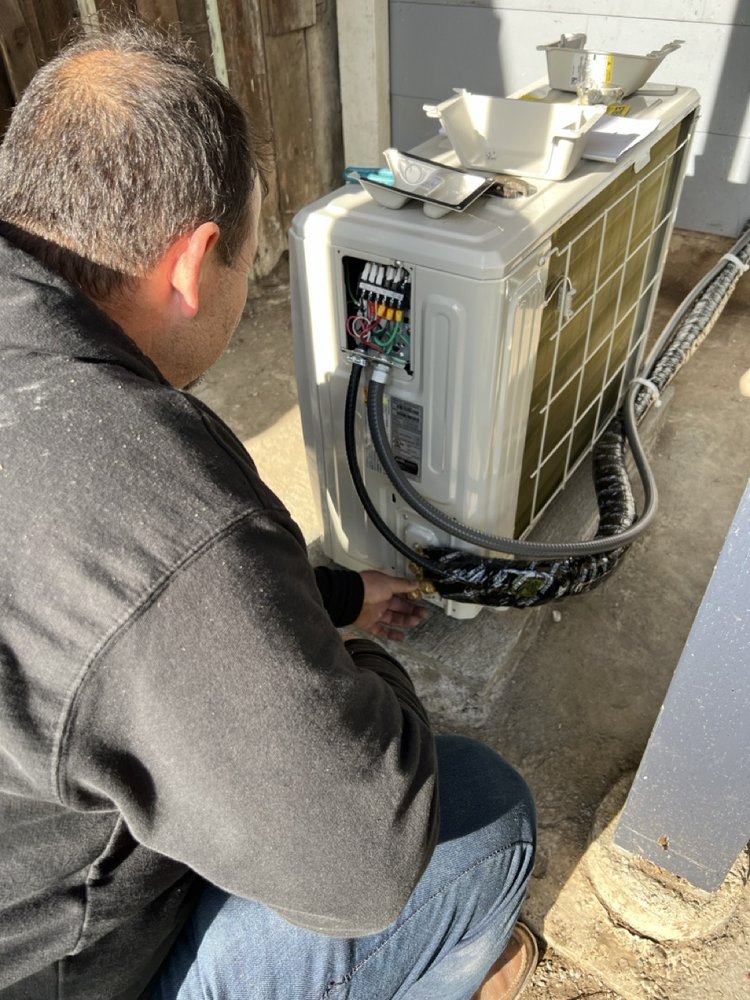 Photo of Building Efficiency - San Francisco, CA, United States. Building Efficiency Team Installing a heat pump condesner.