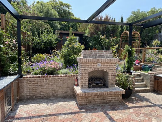 Photo of JML Landscapes - San Francisco, CA, US. After:  brick patio with fireplace, cottage style garden