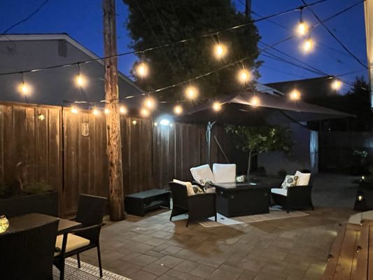 Photo of Ideal Landscape & Concrete - Menlo Park, CA, US. a patio with patio furniture and string lights