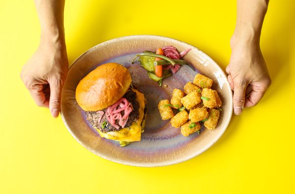 Photo of Yolks - Vancouver, BC, CA. a person holding a plate of food