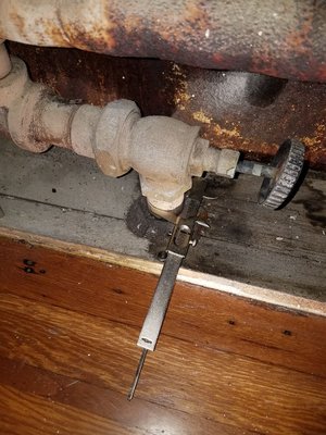 Photo of Pipe Monkeys Sewer and Drain - Maspeth, NY, US. Checking size of radiator valve for replacement.