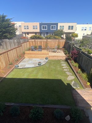 Photo of Logiculture - San Francisco, CA, US. Multi-zone installation to maximize play and entertaining space. Ground alternative lawn space, fire pit patio with built in bench and deck