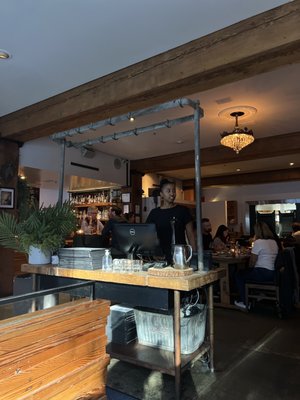 Photo of The Flying Pig - Vancouver, BC, CA. a man working on a computer in a restaurant
