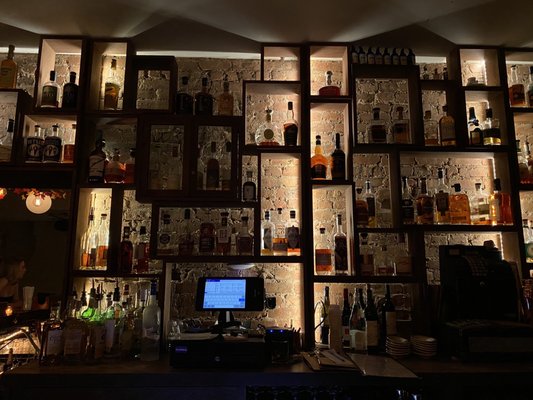 Photo of The Malt House - New York, NY, US. a bar with a lot of liquor bottles