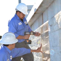 Photo of Pestec - San Francisco, CA, United States. Two technicians installing screen mesh on a vent to keep rodents out.