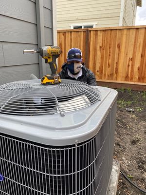 Photo of KC Home Services - Santa Rosa, CA, US. Luis Leon moving an ac to the side yarn