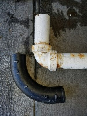 Photo of General SF - San Francisco, CA, US. White pipe is the old galvanized connection has a sharp turn which may be clog. The black pipe is more curvy - less chance of clogging