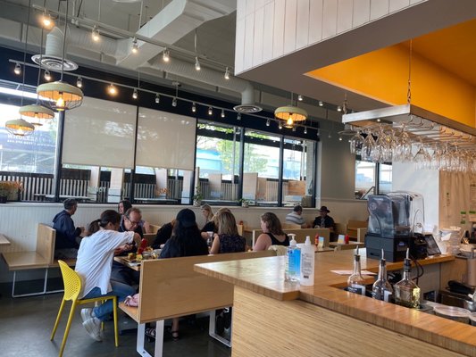 Photo of Yolks - Vancouver, BC, CA. people sitting at tables in a restaurant