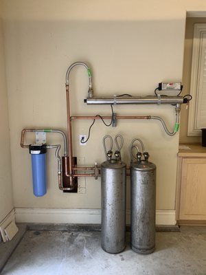 Photo of Rayne Water Conditioning - San Jose, CA, US. Rayne whole-house water filter system installed in our garage (Carbon, Portable Exchange Soft Water filters, and UV filter)