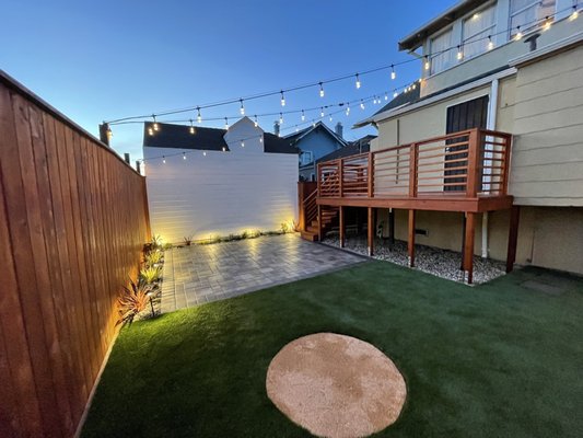 Photo of Vigorous Landscaping - Daly City, CA, US. a backyard with artificial grass and string lights