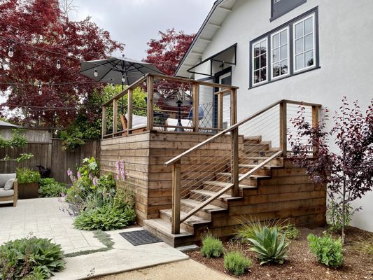Photo of Terra Gardens - Berkeley, CA, US. a wooden deck with steps leading up to a patio