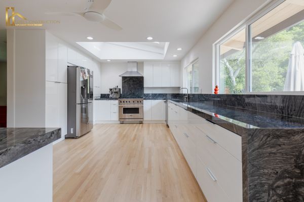 Photo of Edri Construction - San Francisco, CA, US. a modern kitchen with white cabinets and black granite countertops