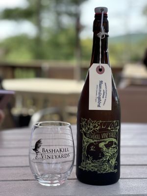 Photo of Bashakill Vineyards - Wurtsboro, NY, US. a bottle of wine and a glass