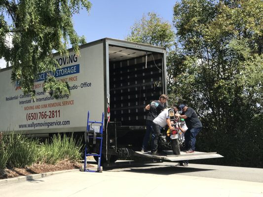 Photo of Wally's Moving & Junk Removal Services - San Mateo, CA, US. Unloading the motorcycle