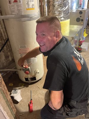 Photo of Atlas Heating - Oakland, CA, US. Ian, senior Atlas service technician, is happy to relight the water heater on our Christmas in August project in West Oakland.