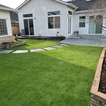 New turf lawn and concrete patio /path.
