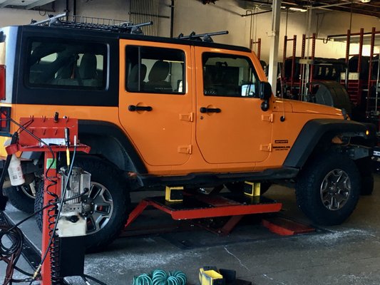 Photo of America's Tire - Millbrae, CA, US. This is my Jeep in the bay getting worked on.