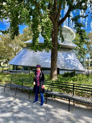 Photo of The Battery - New York, NY, US. My lovely wife standing in front of a pretend UFO...SeaGlass Carousel !