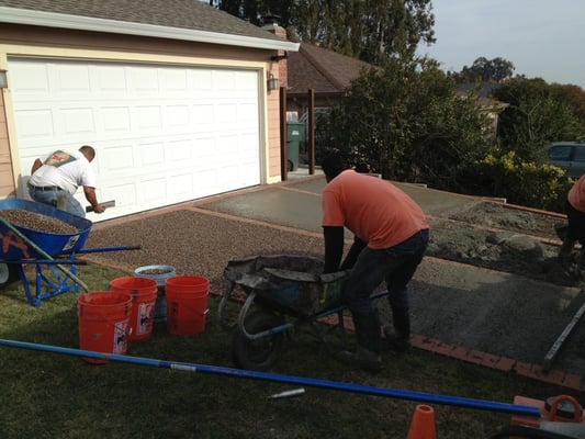 Photo of Ideal Landscape & Concrete - Menlo Park, CA, US. crew working very hard with the newly poured concrete and adding the pami pebbles.
